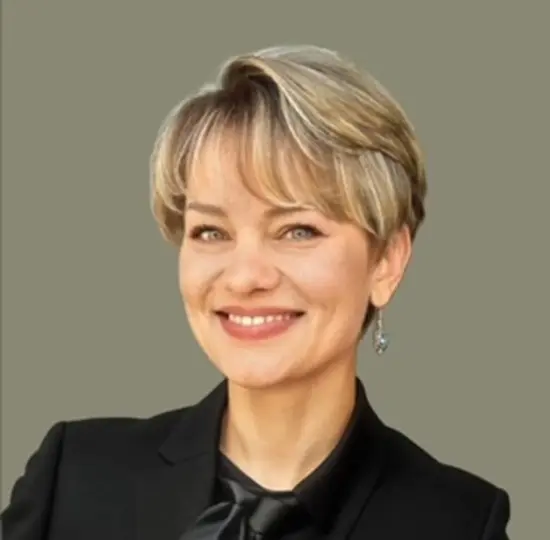 Smiling woman with short blonde hair.